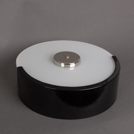 Staircase wall lamp with black finish and opal white, round shaped glass.